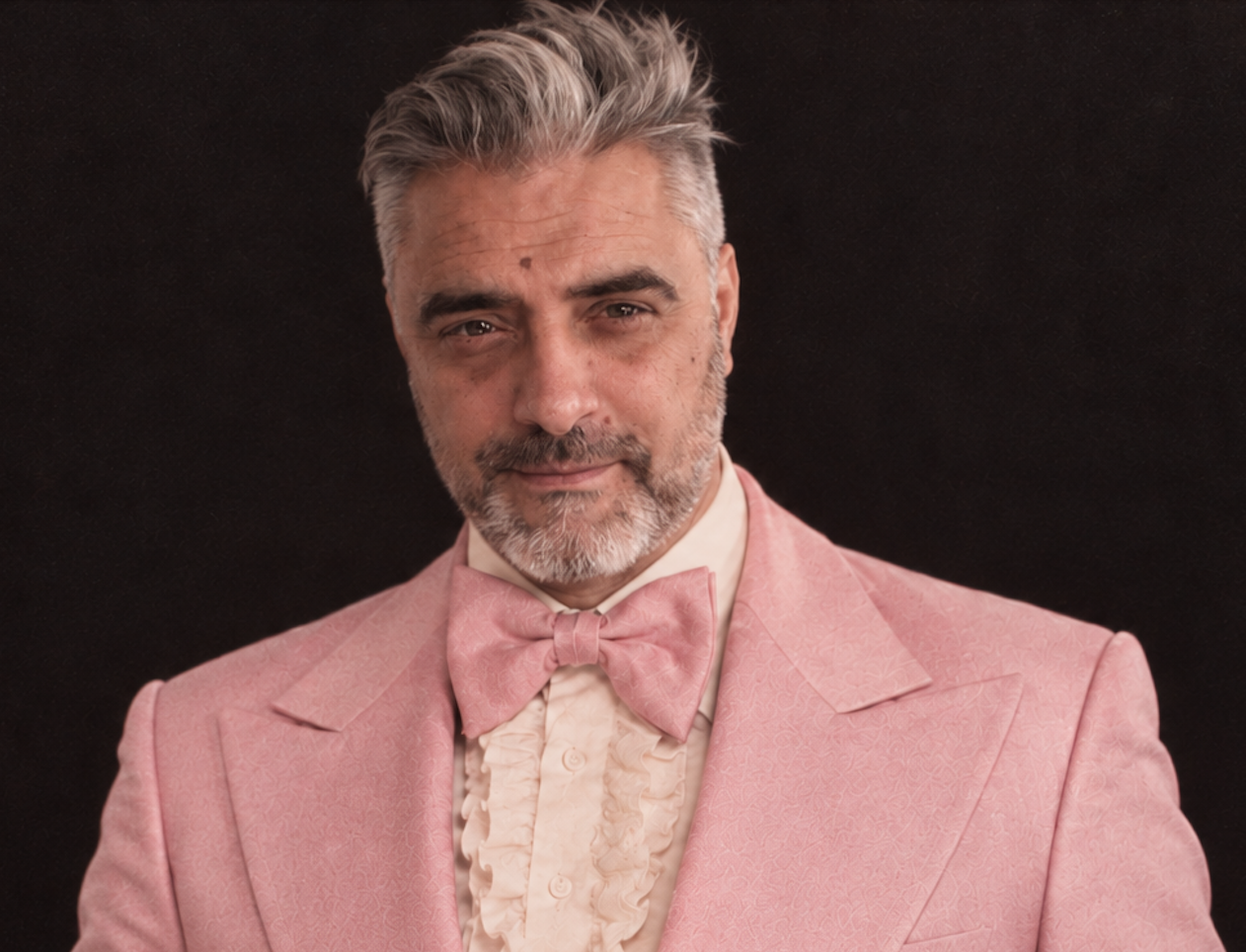 Luke Davis portrait in a pink tuxedo